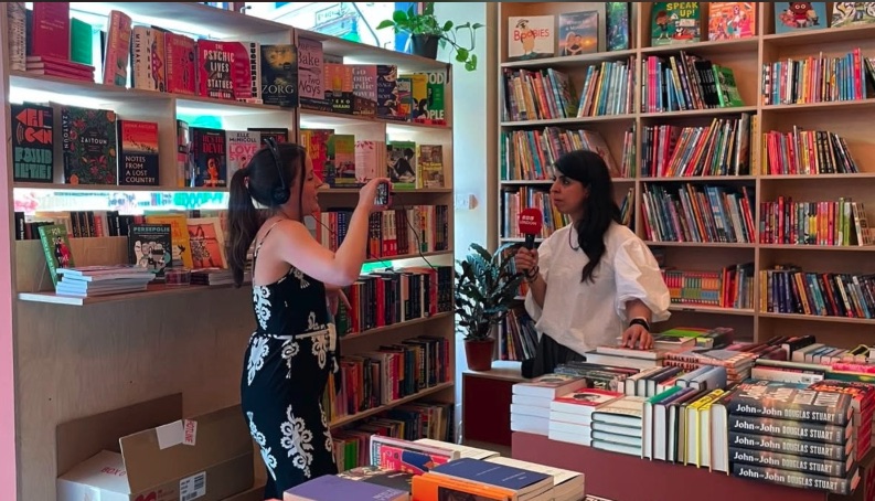 Inside an independent bookshop in Brixton, lined with colourful books
